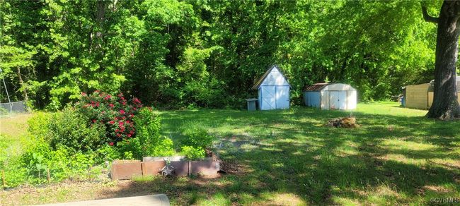 View of yard with fence, a storage shed, and an outbuilding | Image 14