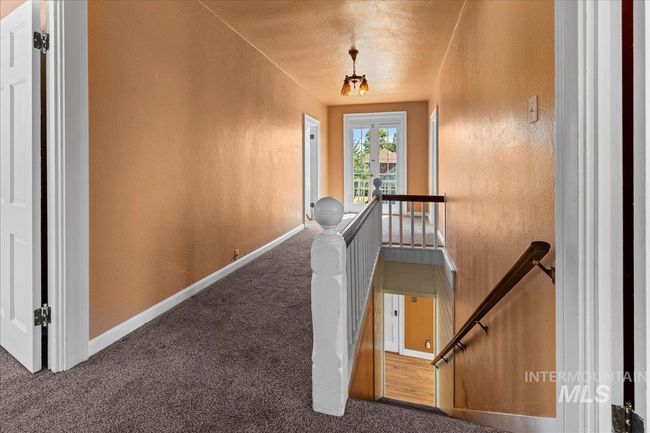 Stairs featuring a textured wall and carpet flooring | Image 32