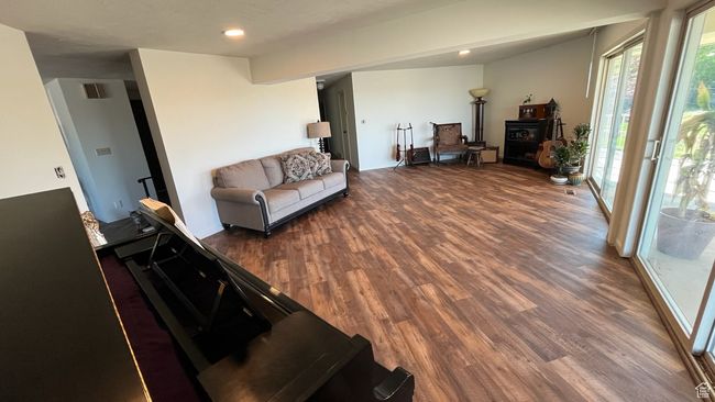 Living room featuring recessed lighting, wood finished floors, and visible vents | Image 26