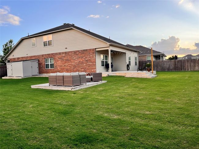Rear view of house featuring a fenced backyard, brick siding, a patio area, and an outdoor living space | Image 37