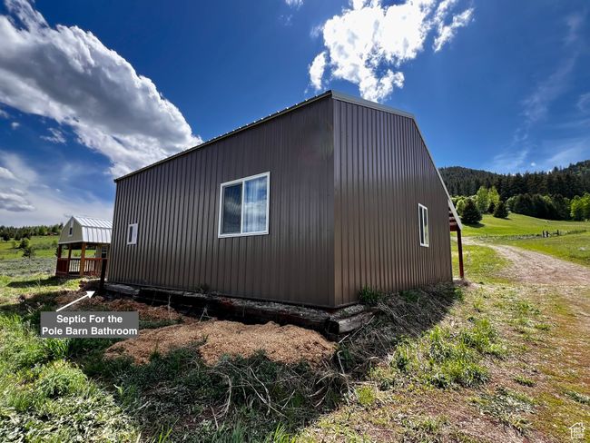 View of property exterior featuring a wooded view | Image 31