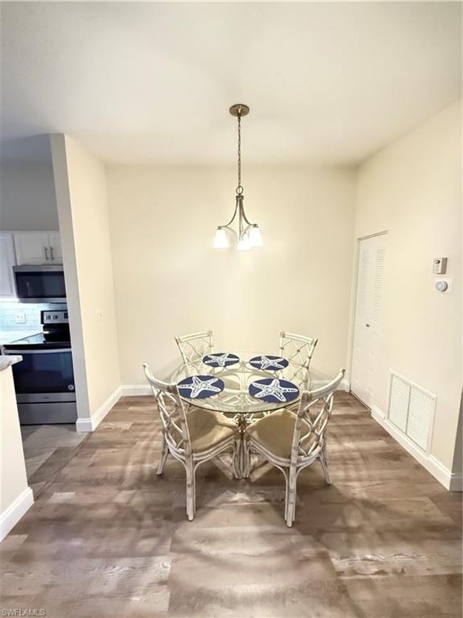 Dining space with wood finished floors, visible vents, and baseboards | Image 6