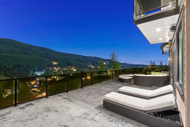 View of patio featuring a balcony, an outdoor hangout area, and a mountain view | Image 39