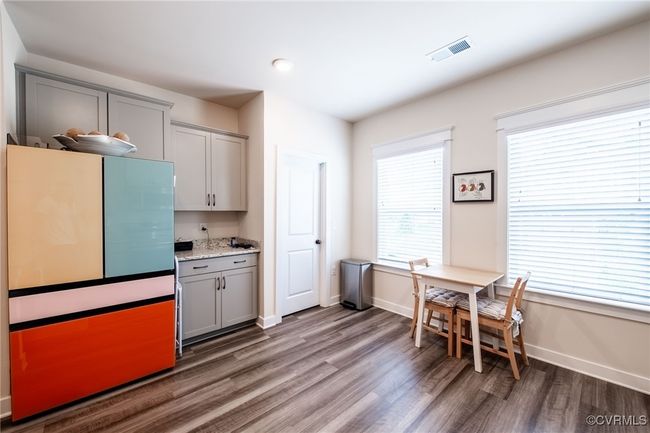 Kitchen featuring gray cabinets, wood finished floors, light stone countertops, and recessed lighting | Image 10