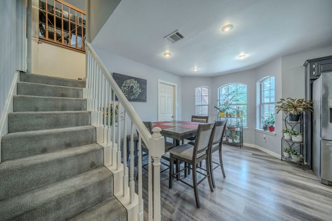 Dining area featuring stairs, wood finished floors, and recessed lighting | Image 12