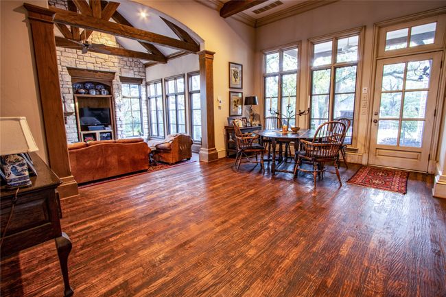 Dining area featuring beamed ceiling, visible vents, wood finished floors, and a healthy amount of sunlight | Image 8