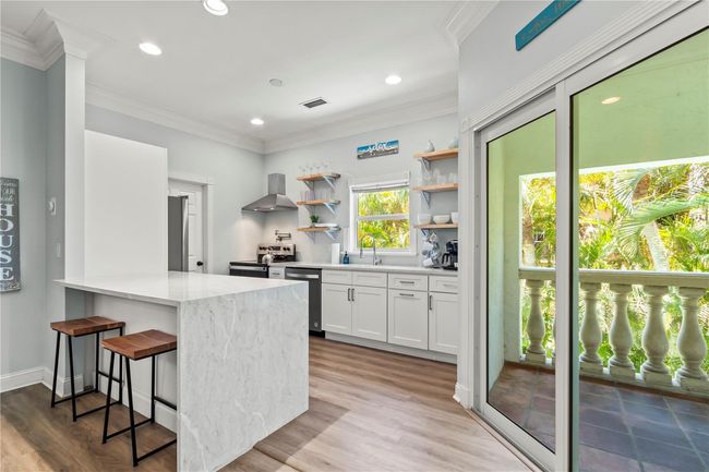 Counter seating in the kitchen and impact sliding door to covered lanai | Image 13