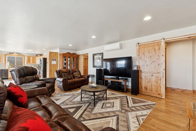 Living room with a barn door and an AC wall unit | Image 34