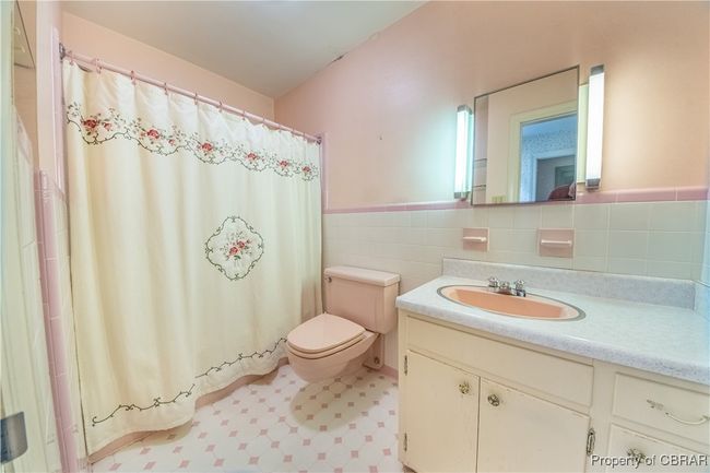 Bathroom featuring vanity, toilet, and tile walls | Image 26