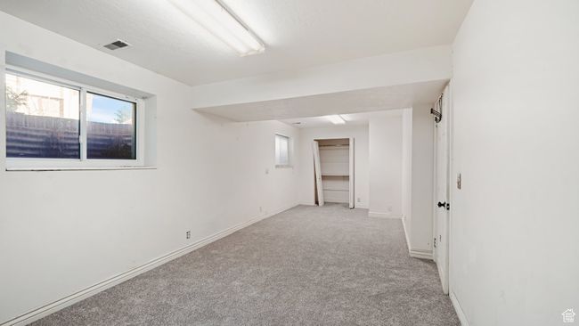Empty room featuring light colored carpet, visible vents, and baseboards | Image 22