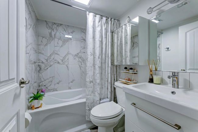 Full bathroom with shower / tub combo with curtain, toilet, and vanity | Image 17