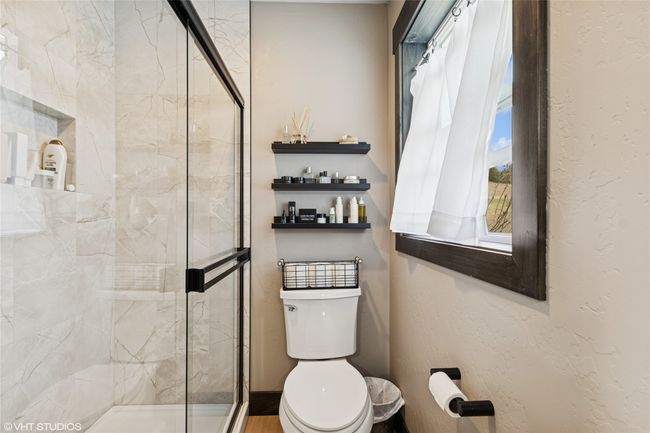 Bathroom featuring toilet and a shower stall | Image 28