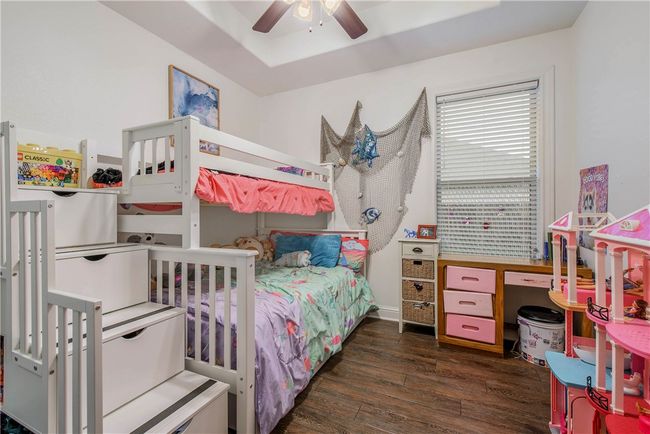 Bedroom featuring wood finished floors and ceiling fan | Image 21