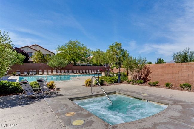 Community pool with a community hot tub, a fenced backyard, and a patio area | Image 75