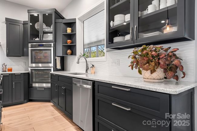 Primary Kitchen Space with Modern Cabinetry, counters and appliances. | Image 11