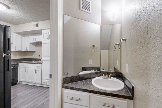 Bathroom featuring visible vents, a textured ceiling, a textured wall, and a sink | Image 26