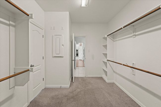 The walk-in closet in the primary suite is open to the laundry room | Image 18