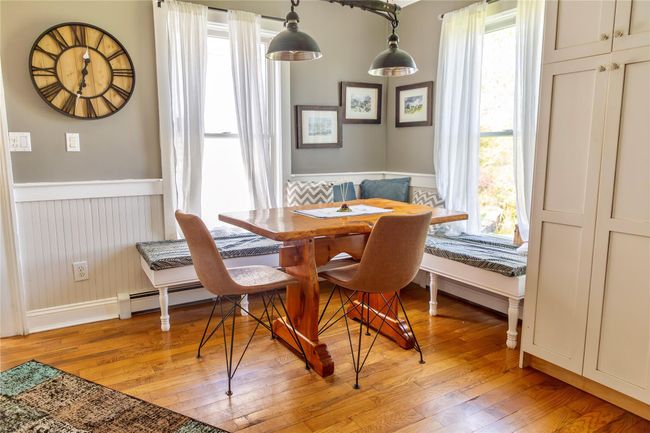 Dining area featuring breakfast area, wainscoting, light wood-style flooring, and baseboards | Image 21