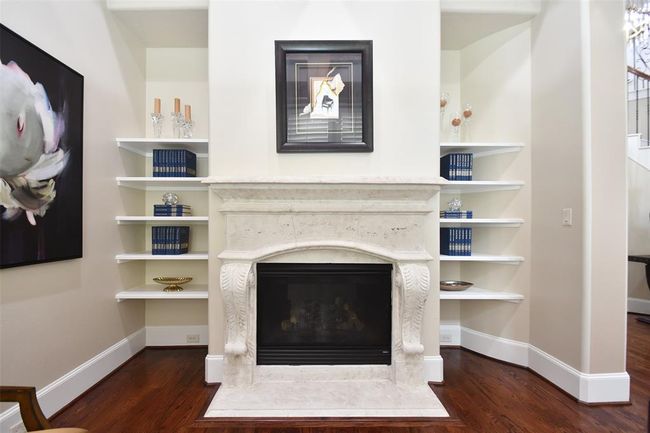 Elegant spiral staircase adorned with stained treads and white risers. Custom wrought iron spindles adds a touch of sophistication this Fairmont home embodies. | Image 8