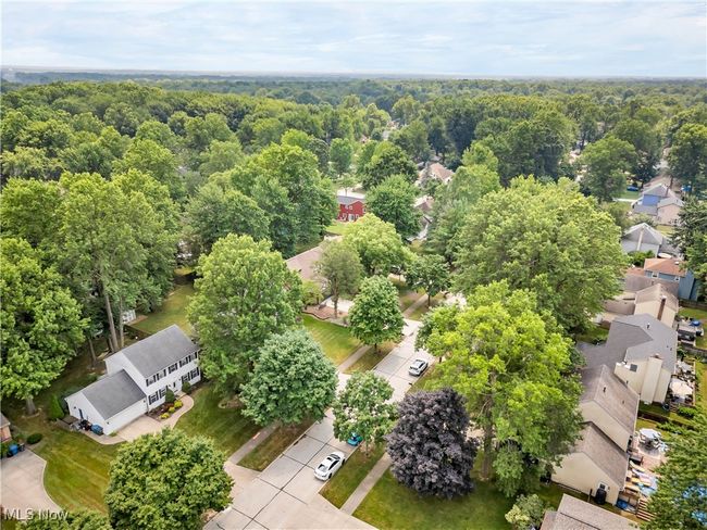 Aerial perspective of suburban area featuring a heavily wooded area | Image 38
