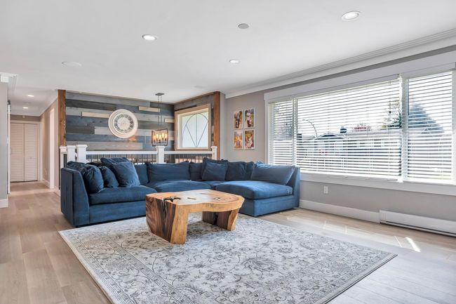 Living room featuring light wood-style flooring, recessed lighting, ornamental molding, and baseboards | Image 11