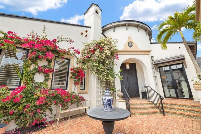 View of front of property featuring a chimney and stucco siding | Image 6