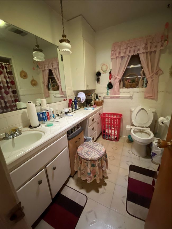 Full bath with tile patterned floors, vanity, and toilet | Image 15
