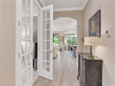 From the foyer entrance, den to the left and your main living areas ahead | Image 3