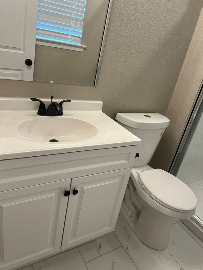 Full bath featuring marble finish flooring, vanity, toilet, and a shower | Image 28
