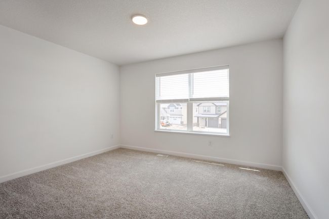 Photo is of the actual home. All three secondary bedrooms come with a spacious closet! | Image 13