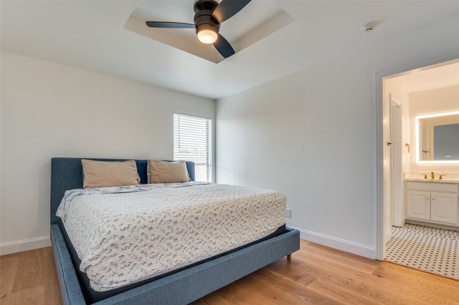 Bedroom with baseboards, light wood-style floors, a sink, and a ceiling fan | Image 28