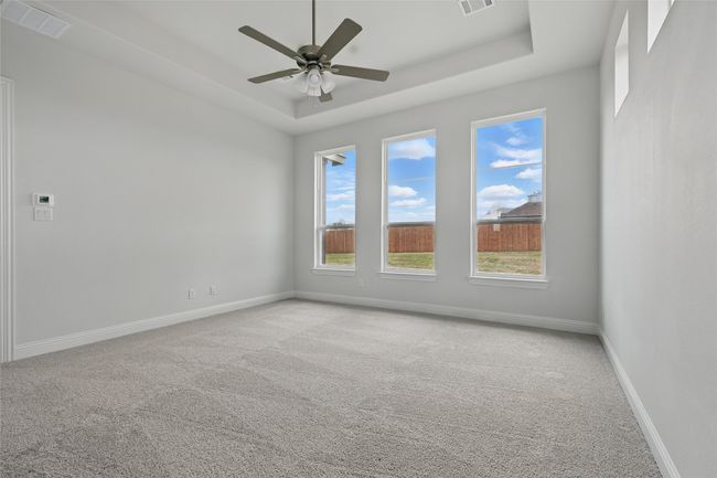 Unfurnished room with baseboards, visible vents, carpet flooring, and a raised ceiling | Image 16