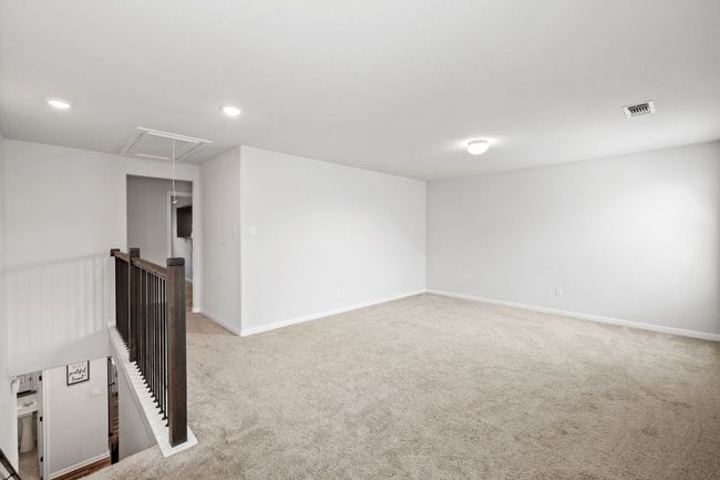 Empty room featuring attic access, baseboards, carpet flooring, visible vents, and recessed lighting | Image 17