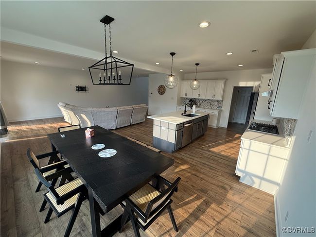 Dining space with recessed lighting, dark wood-type flooring, baseboards, and a chandelier | Image 26
