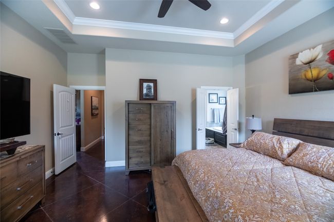 Bedroom featuring a raised ceiling, ornamental molding, recessed lighting, baseboards, and ceiling fan | Image 20