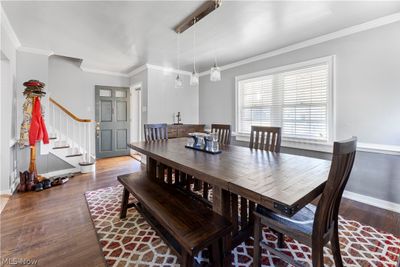 Dining area with wood-type flooring and ornamental molding | Image 3