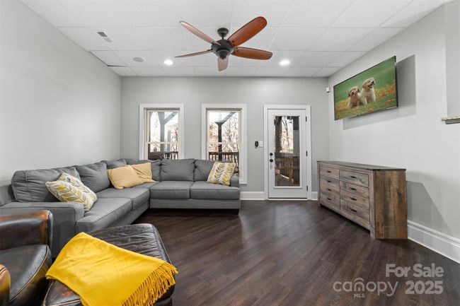 First den area in basement is cozier with direct access to side porch. | Image 25