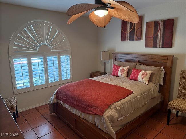 Bedroom featuring tile patterned flooring, a ceiling fan, and baseboards | Image 5