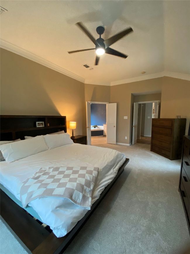 Bedroom featuring ornamental molding, visible vents, and light colored carpet | Image 19