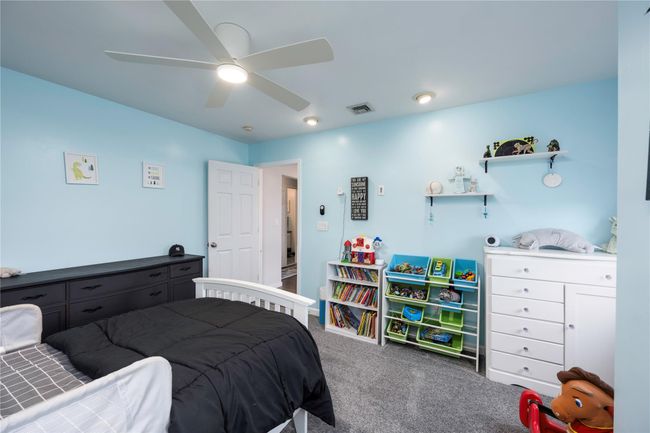Bedroom featuring ceiling fan, lofted ceiling, and light colored carpet | Image 24