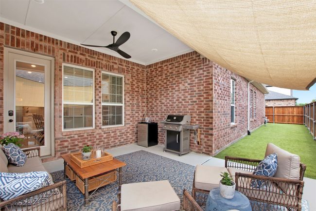 View of patio with outdoor lounge area, ceiling fan, and grilling area | Image 28
