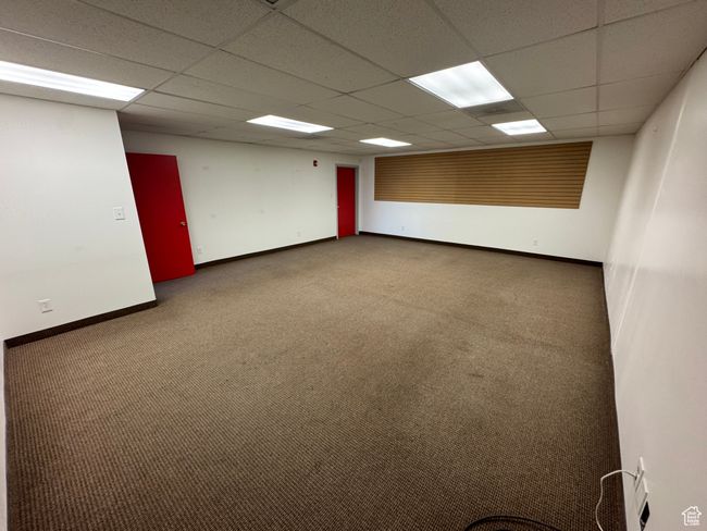 Carpeted empty room featuring baseboards and a drop ceiling | Image 5