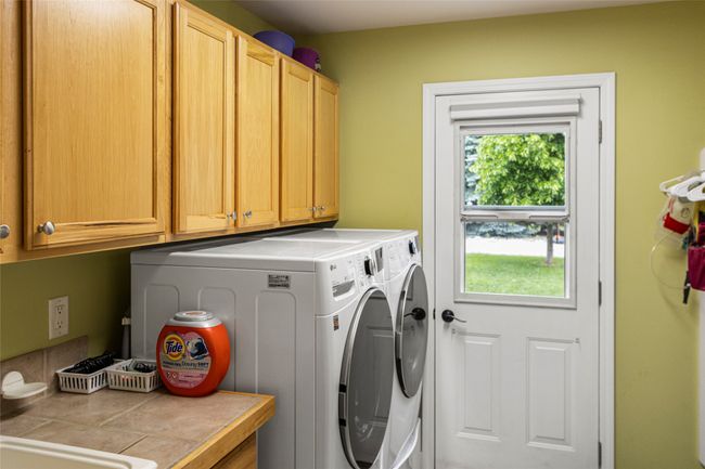 Washroom featuring cabinet space and washer and clothes dryer | Image 29