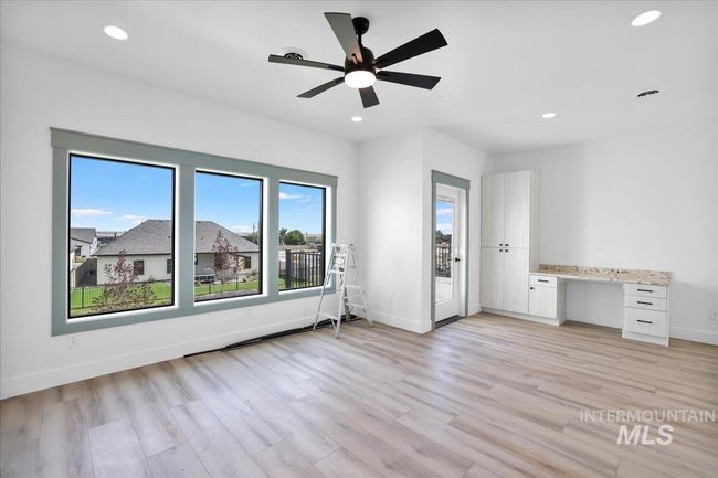Spare room with recessed lighting, light wood-style flooring, a ceiling fan, and built in desk | Image 50