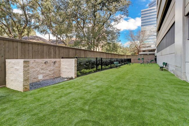 Gated pet park at the rear of the building featuring a pet grooming station—an ideal space for pets to play and socialize. | Image 28