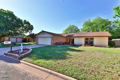 Single story home featuring a garage and a front lawn | Image 2