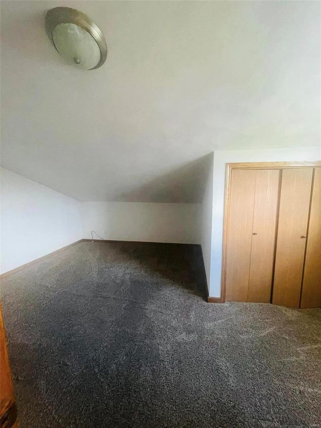 Bonus room featuring vaulted ceiling and carpet | Image 14
