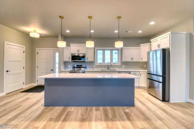 Large Island with Quartz Counters and Pendant Lighting | Image 12
