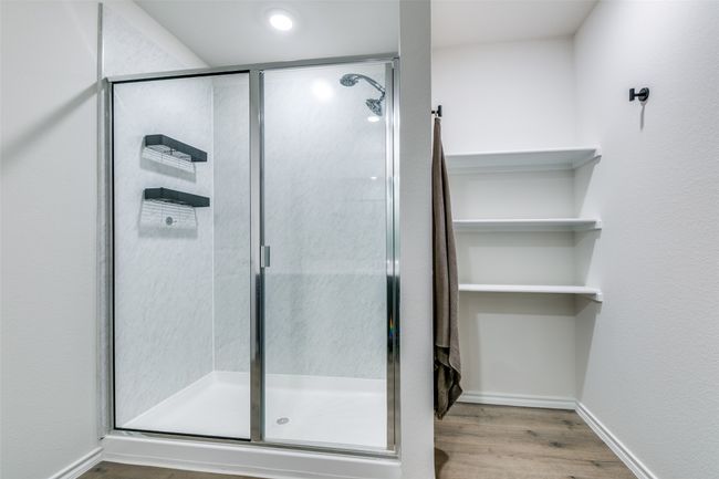 Bathroom with wood-type flooring and an enclosed shower | Image 14