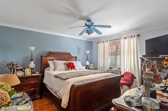 Bedroom featuring hardwood / wood-style flooring, ornamental molding, and ceiling fan | Image 10